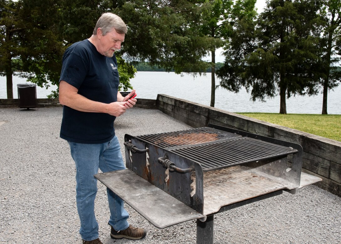 Gary Heesaker, park contract inspector with the U.S. Army Corps of Engineers Nashville District at J. Percy Priest Lake, inspects a grill for cleanliness at Anderson Road Day Use Area May 5, 2023, in Nashville, Tennessee. (USACE Photo by Lee Roberts)