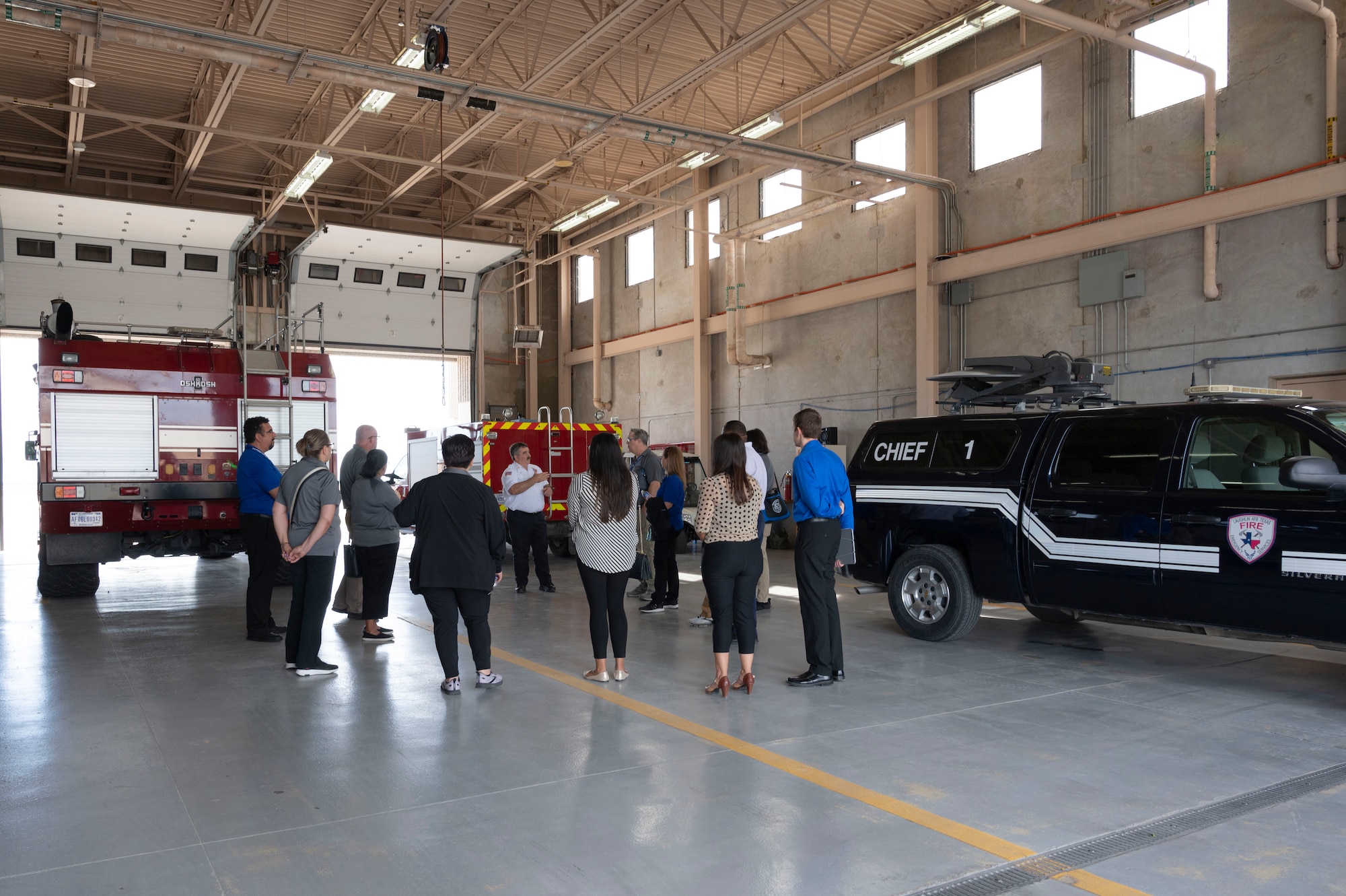 Members from the Career and Technical Education (CTE) Center speak with David Isbell, 47th Civil Engineering Squadron fire chief, during a base tour at Laughlin Air Force Base, Texas, on May 1, 2023. This tour event gave the CTE group a chance to see first-hand how Laughlin’s Grow Your Own program is able to provide local students a wide variety of courses in technical knowledge and hands-on training skills. (U.S. Air Force photo by Airman 1st Class Kailee Reynolds)