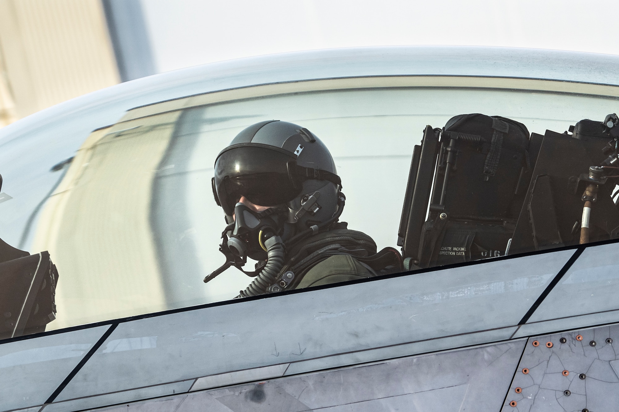 U.S. Air Force Lt. Col. Philip Johnson looking out from the cockpit of an F-22 Raptor fighter jet