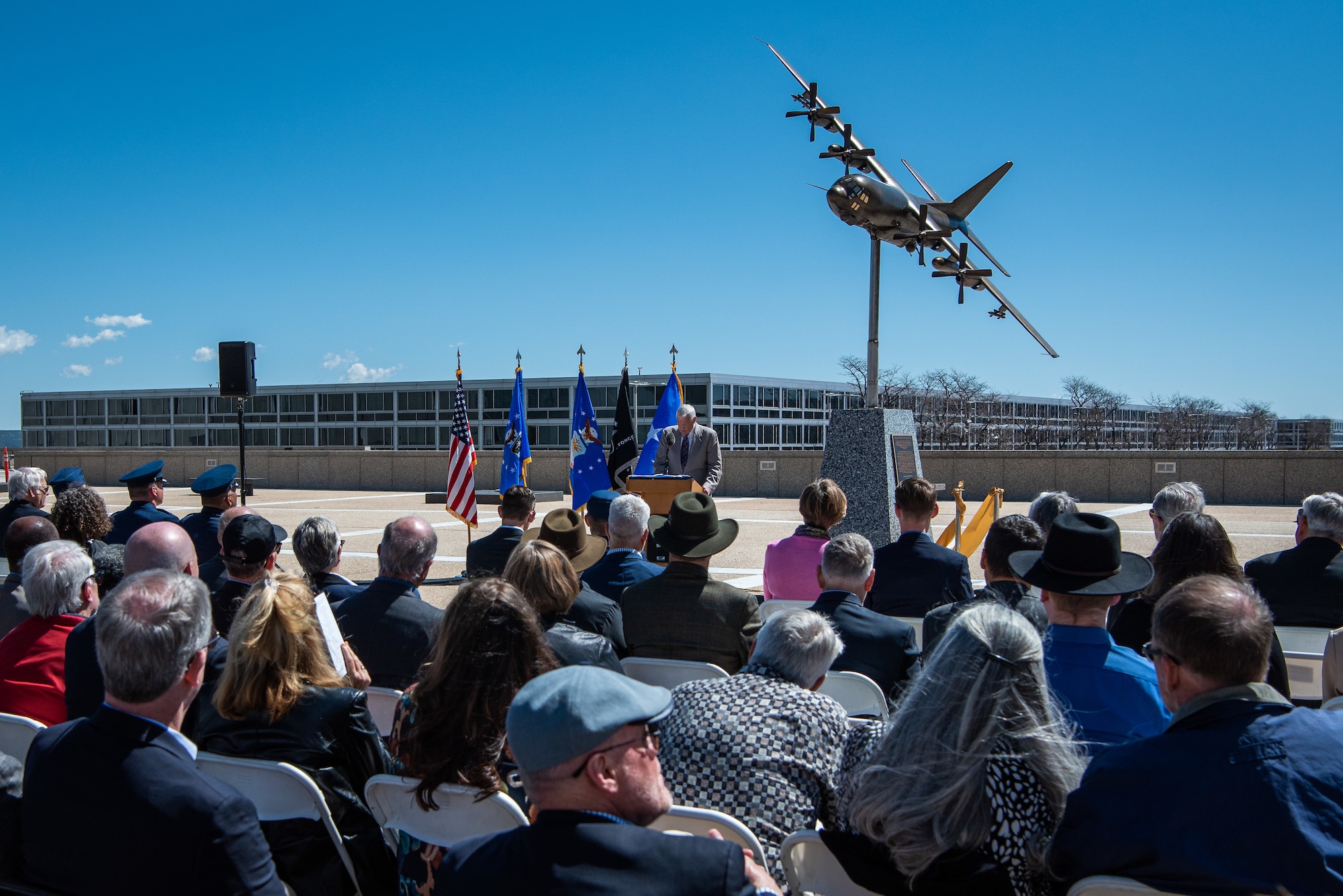 Michael Van Hoomissen, U.S. Air Force Academy Class of 1979 president, gives a speech in front of a crowd to commemorate a sculpture of an AC-130H Spectre gunship, call sign Spirit 03, during a ceremony at the Air Force Academy Colorado on May 5, 2023.