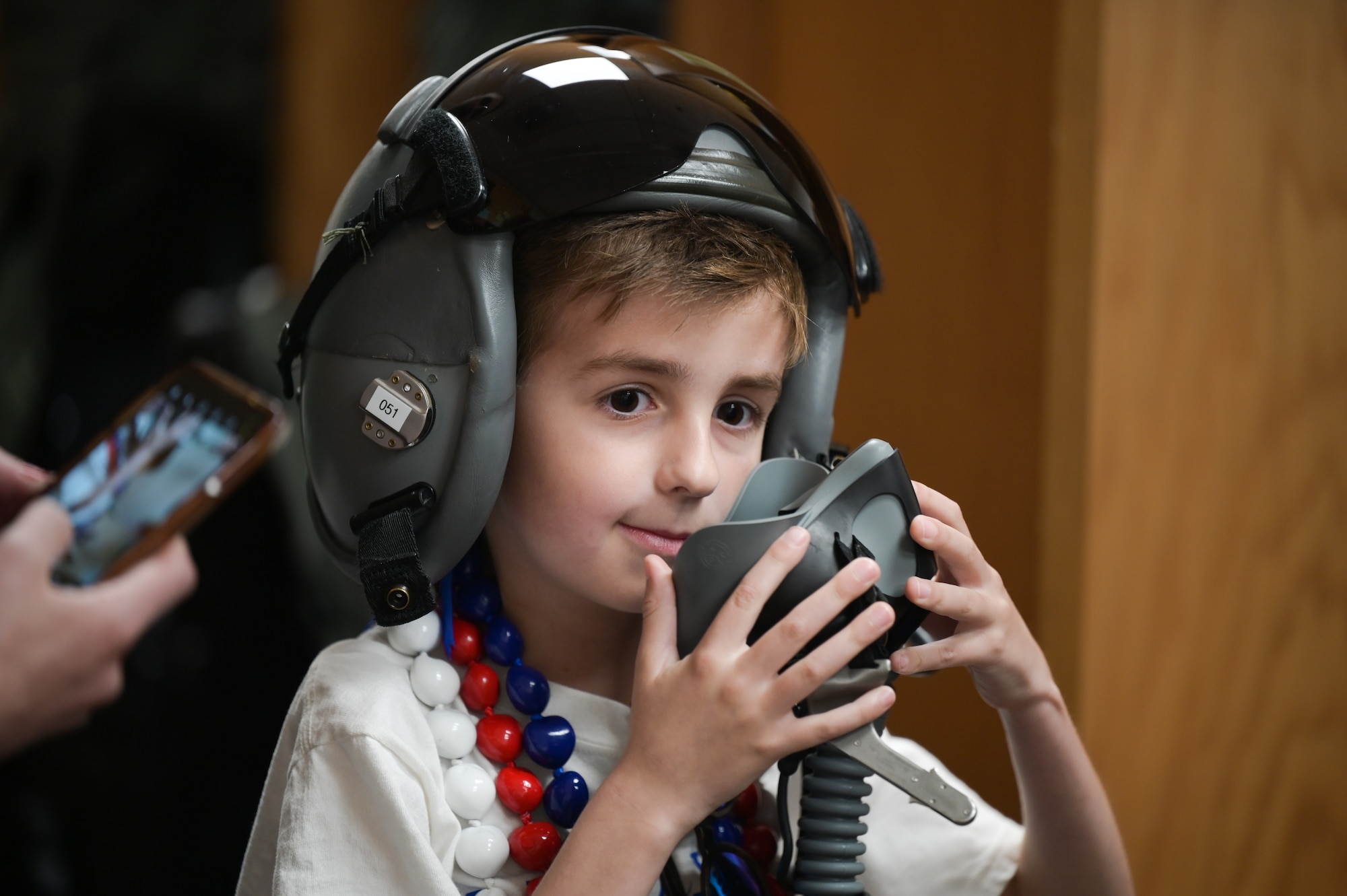 Elliott from the Make-A-Wish Foundation of Greater Los Angeles tests an F-22 Raptor pilot helmet during a tour of the 19th and 199th Fighter Squadrons at Joint Base Pearl Harbor-Hickam, Hawaii, May 5, 2023. Elliot learned the capabilities of the F-22 and the pilot’s equipment during his visit. (U.S. Air Force photo by Staff Sgt. Alan Ricker)
