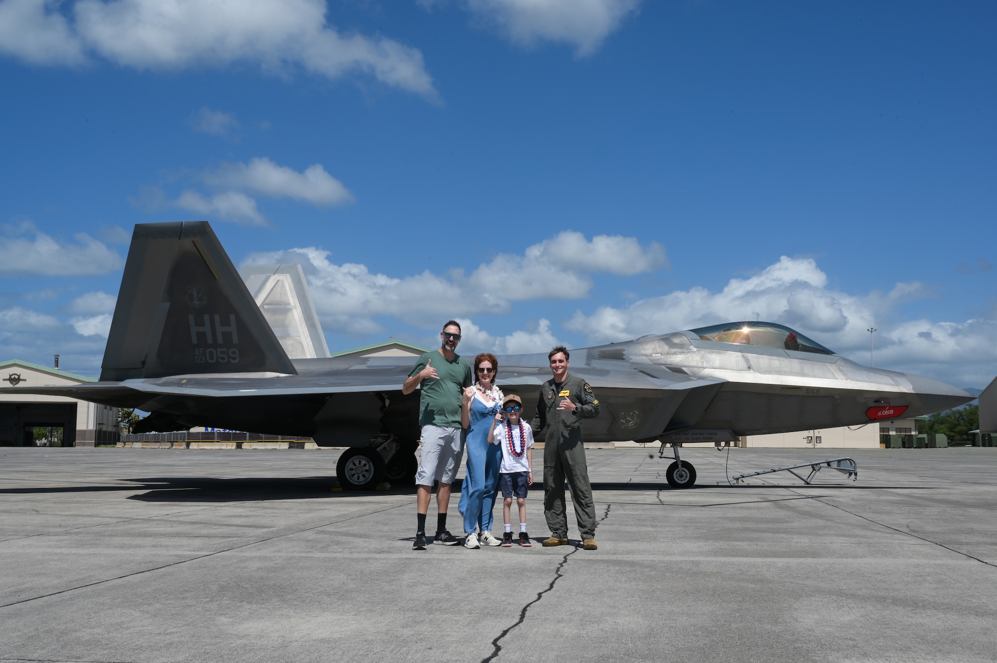 Elliott from the Make-A-Wish Foundation of Greater Los Angeles, his parents, and 1st Lt. Benjamin Peila, 199th Fighter Squadron F-22 Raptor pilot, pose for a photo in front of an F-22 at Joint Base Pearl Harbor-Hickam, Hawaii, May 5, 2023. The 15th Wing and the 154th Wing hosted Elliott, showcasing the 19th and 199th Fighter Squadrons and the F-22. (U.S. Air Force photo by Staff Sgt. Alan Ricker)