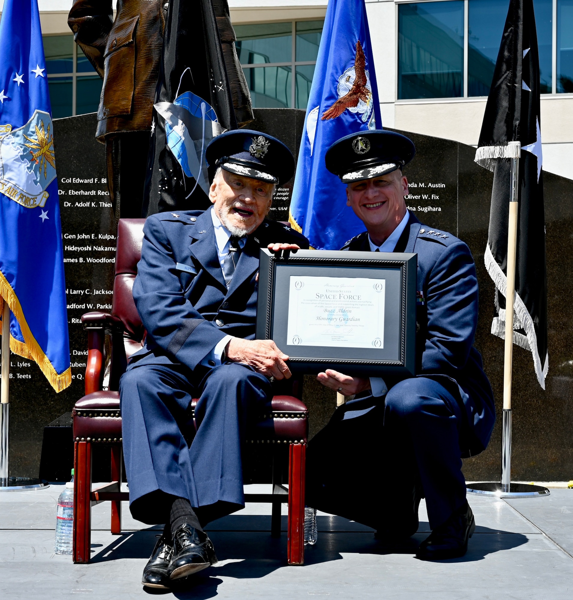 Space Force Lt. Gen. Michael Guetlein, Space Systems Commander (right) presents the Honorary Guardian certificate to retired Air Force Brig. Gen. Buzz Aldrin (left) during his promotion ceremony at Space Systems Command on May 5, 2023. “In addition to being promoted to a one-star in the Air Force, Brig. Gen. Aldrin is being made on Honorary Space Force Guardian,” stated Guetlein. “He has lived a life epitomizing the Space Force Guardian values of character, connection, commitment, and courage.” (U.S. Space Force photo by Lt. Katelin Robinson)