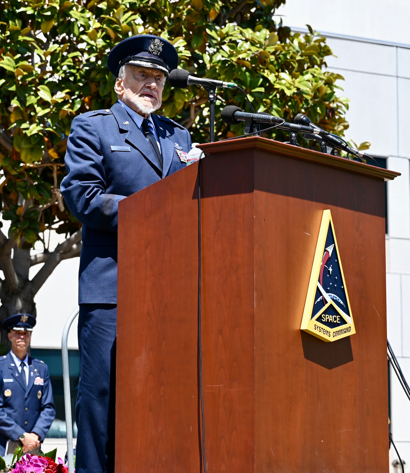 Retired Brig. Gen. Buzz Aldrin addresses crowd during his honorary promotion ceremony at Space Systems Command on May 5, 2023. Aldrin, a notable recipient of the Presidential Medal of Freedom, Air Force Distinguished Service Medal, Legion of Merit, two Distinguished Flying Crosses, and three Air Medals, proudly served in the ranks for more than 21 years, while breaking barriers for the nation’s advancements within space. (U.S. Space Force photo by Lt Katelin Robinson)