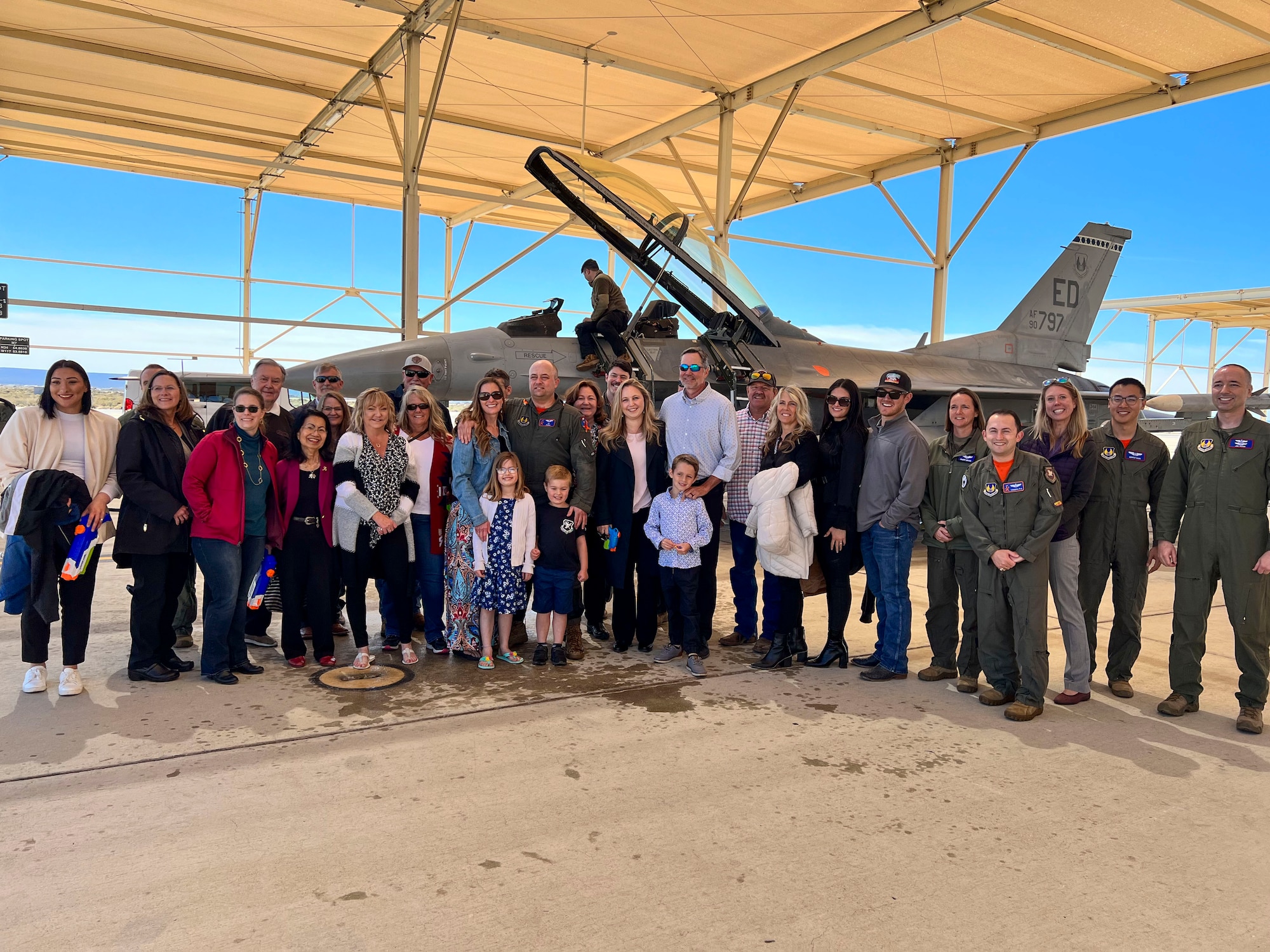 Lt. Col. Matthew Taranto, Chief Aerospace Physiologist, U.S. Air Force Test Pilot School takes a picture with his family and friends after conducting his "fini-flight" before retirement March 31st. (Photo courtesy of Staff Sgt. Elizabeth Taranto)