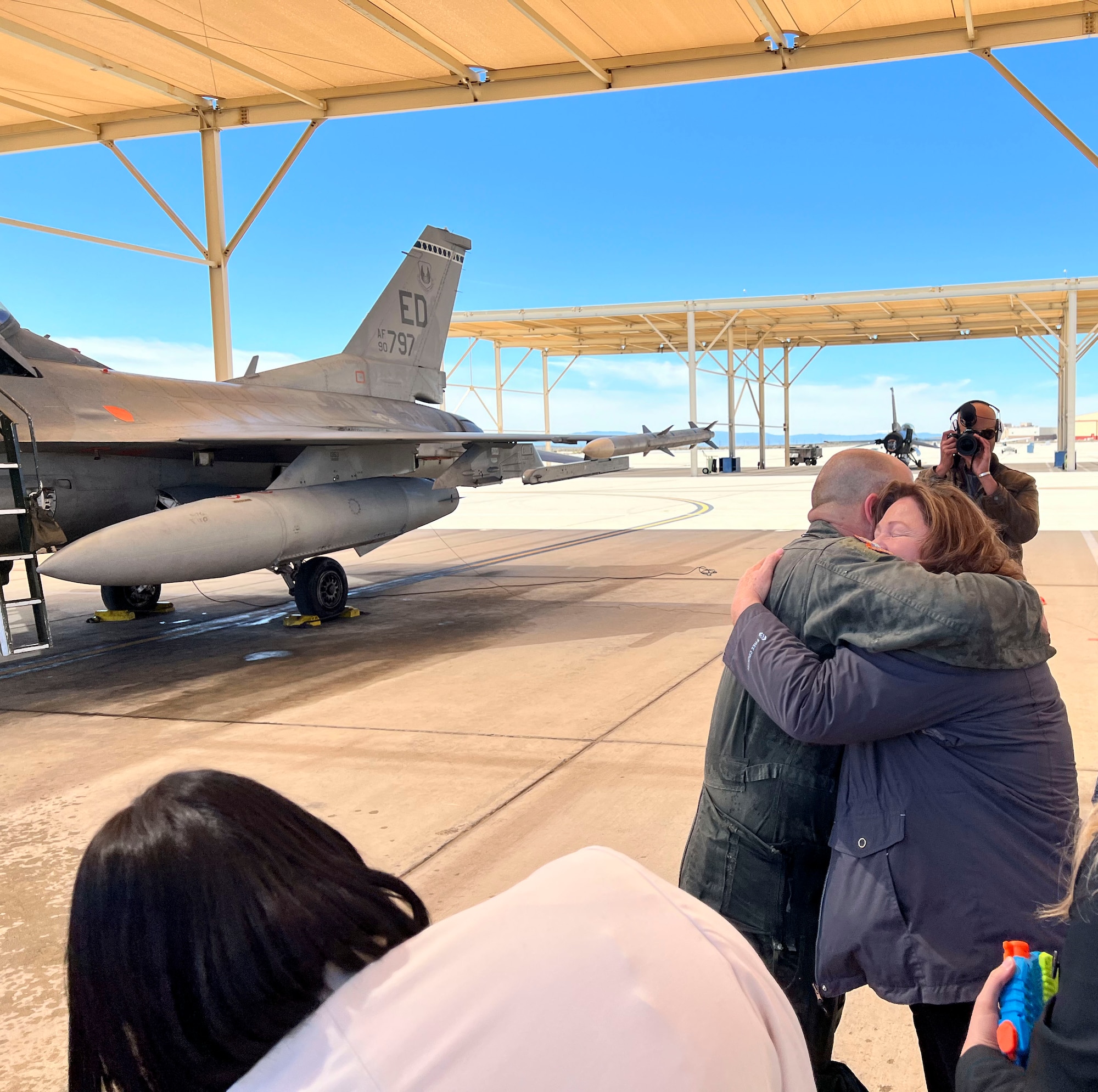 Lt. Col. Matthew Taranto, Chief Aerospace Physiologist, U.S. Air Force Test Pilot School greets his family after conducting his "fini-flight" before retirement March 31st. (Photo courtesy of Staff Sgt. Elizabeth Taranto)