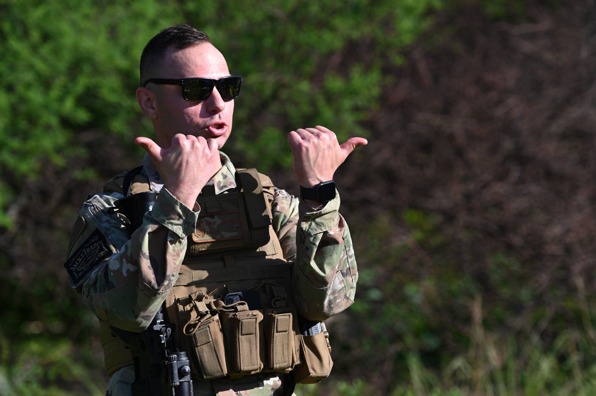 U.S. Air Force Master Sgt. Mike Alberti, 47th Security Forces Squadron superintendent of plans and programs, demonstrates the splitting of a line formation with hand gestures at Laughlin Air Force Base, Texas, on April 28, 2023.