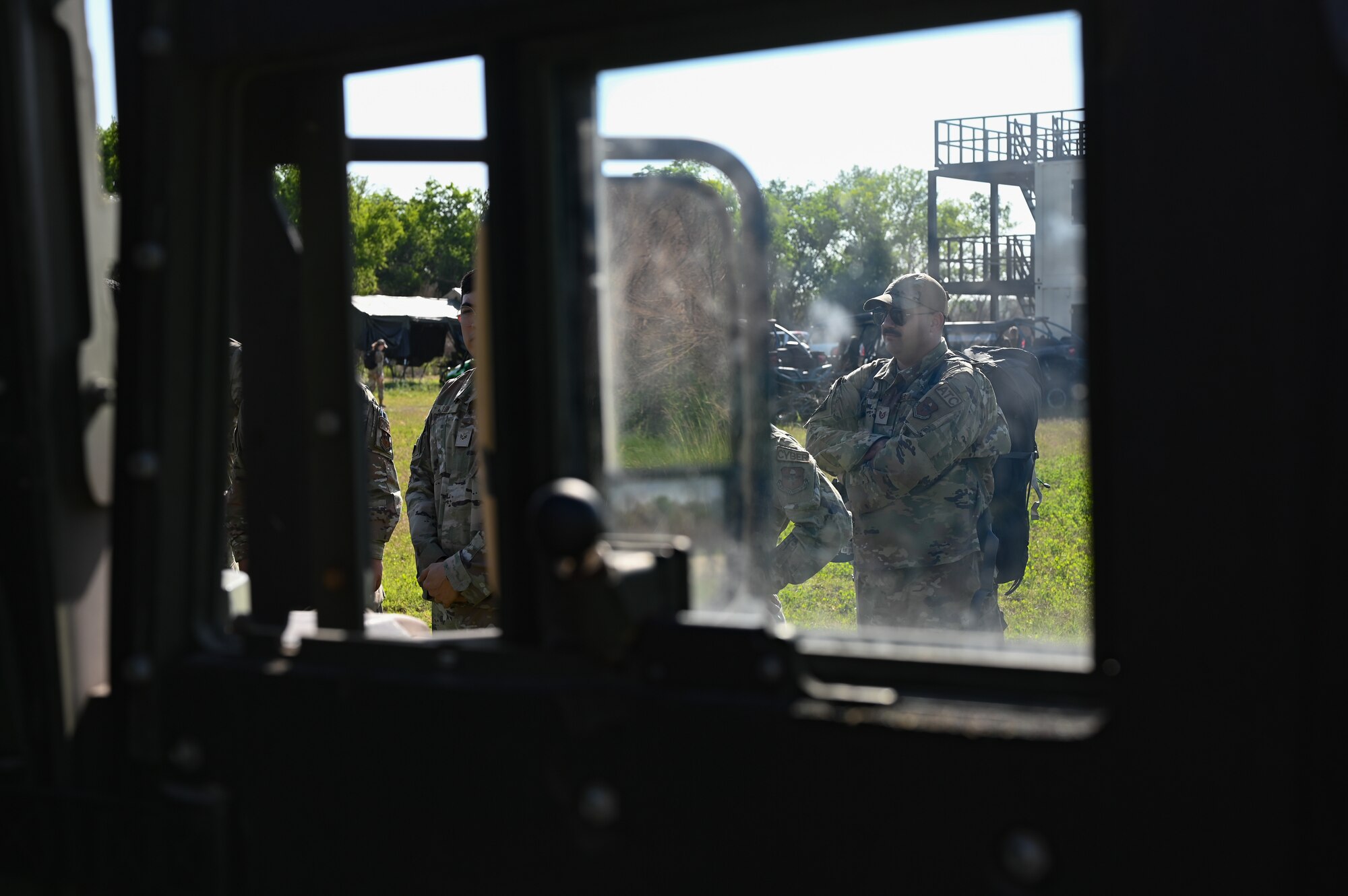 U.S. Air Force Tech. Sgt. Corey Woerner, 47th Mission Support Group non-commissioned officer in charge of Air Traffic Control standardization and evaluation, stands outside the window of a Humvee during training at Laughlin Air Force Base, Texas, on April 28, 2023.