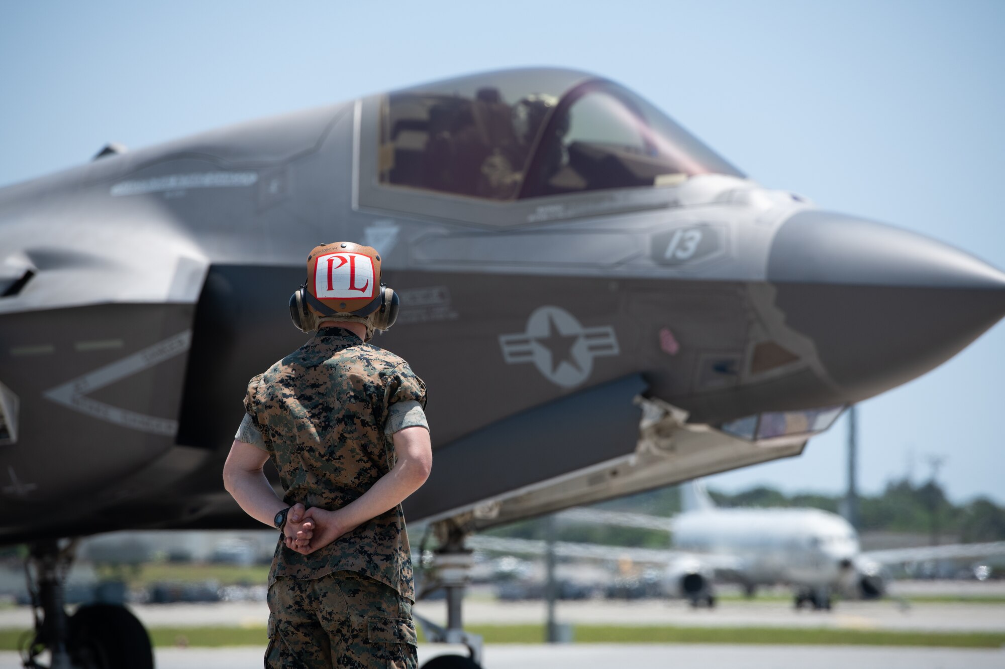 A Marine stands at parade rest.