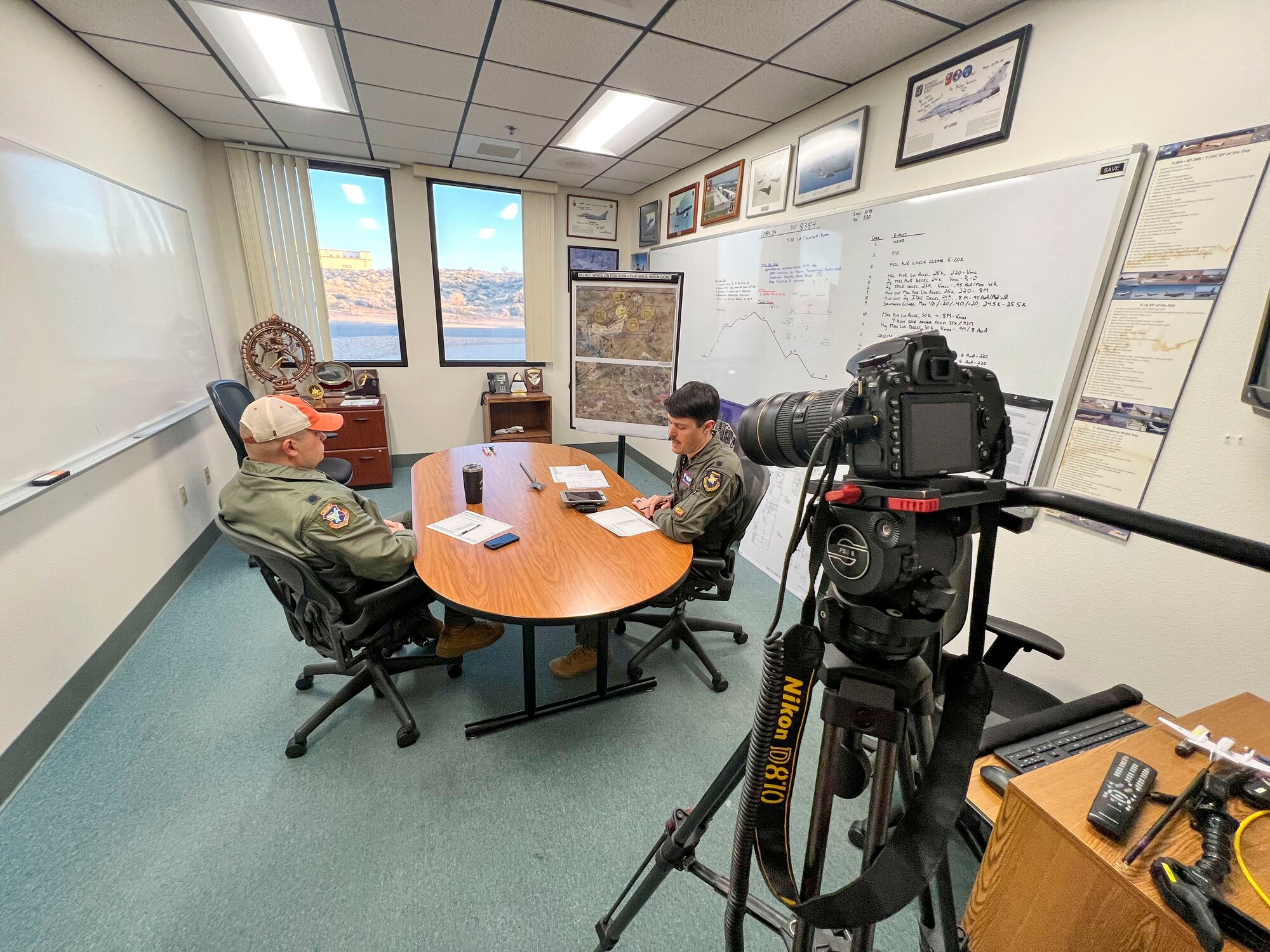 Lt. Col. Matthew Taranto, Chief Aerospace Physiologist, U.S. Air Force Test Pilot School briefs with Lt. Col. Christopher Taylor, U.S. Test Pilot School before conducting his "fini-flight" before retirement March 31st. (Photo courtesy of Staff Sgt. Elizabeth Taranto)