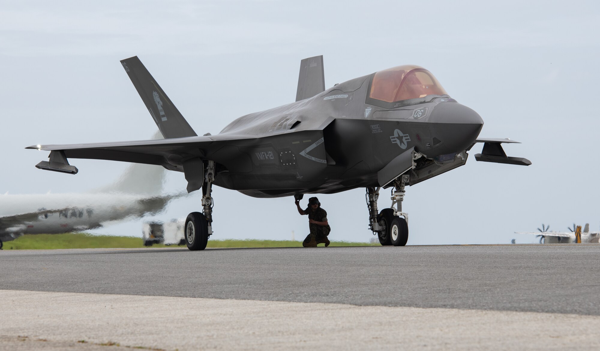 A Marine checks an aircraft after landing.