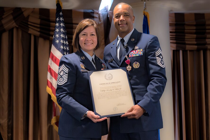 Photo of Chief Master Sergeant of the Air Force JoAnne Bass and Chief Master Sgt. Timothy White holding a certificate of appreciation.