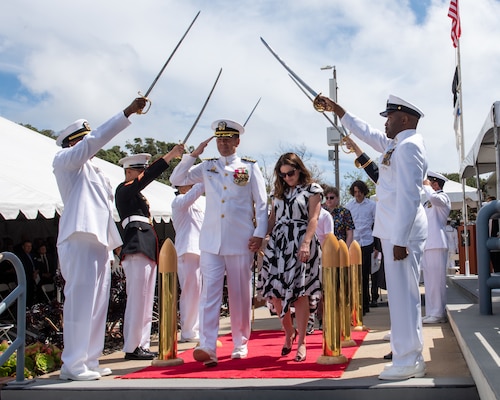 Capt. Andrew Gainer, former commanding officer, Naval Information Warfare Center Pacific, departs through side boys after turning over command to Capt. Patrick McKenna and retiring May 4, 2023. McKenna assumed command from Gainer during the ceremony.
