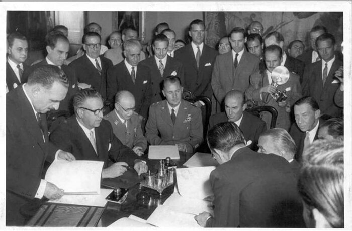 A photo of people signing a document.