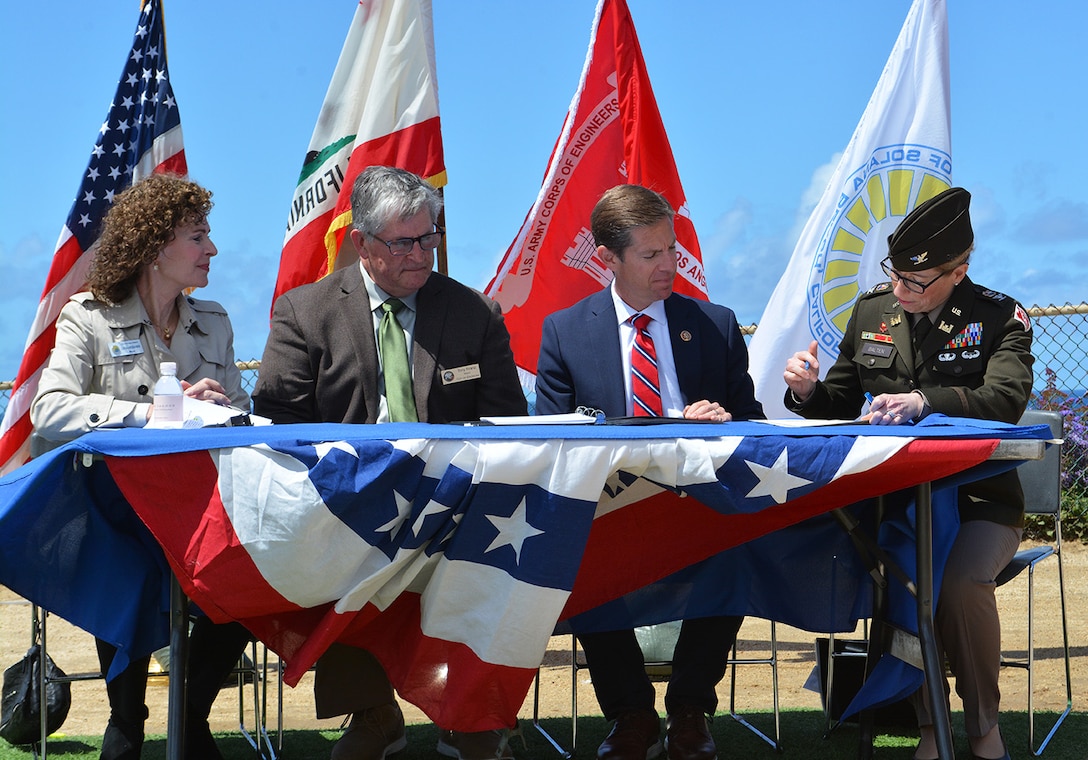 From left to right: Lesa Heebner, mayor of Solana Beach; Tony Kranz, mayor of Encinitas; U.S. Congressman Mike Levin, 49th Congressional District, California; and Col. Julie Balten, commander of the U.S. Army Corps of Engineers Los Angeles District, sign a ceremonial Project Partnership Agreement for the San Diego County (Encinitas and Solana Beach) Shoreline Protection Project during a May 4 press conference at the Fletcher Cove Community Center in Solana Beach, California.