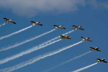 Planes fly in formation.