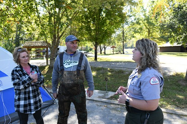 Park Ranger Ashley Webster speaks with a couple visiting Center Hill Lake campgrounds at Center Hill Lake in Lancaster, Tennessee.