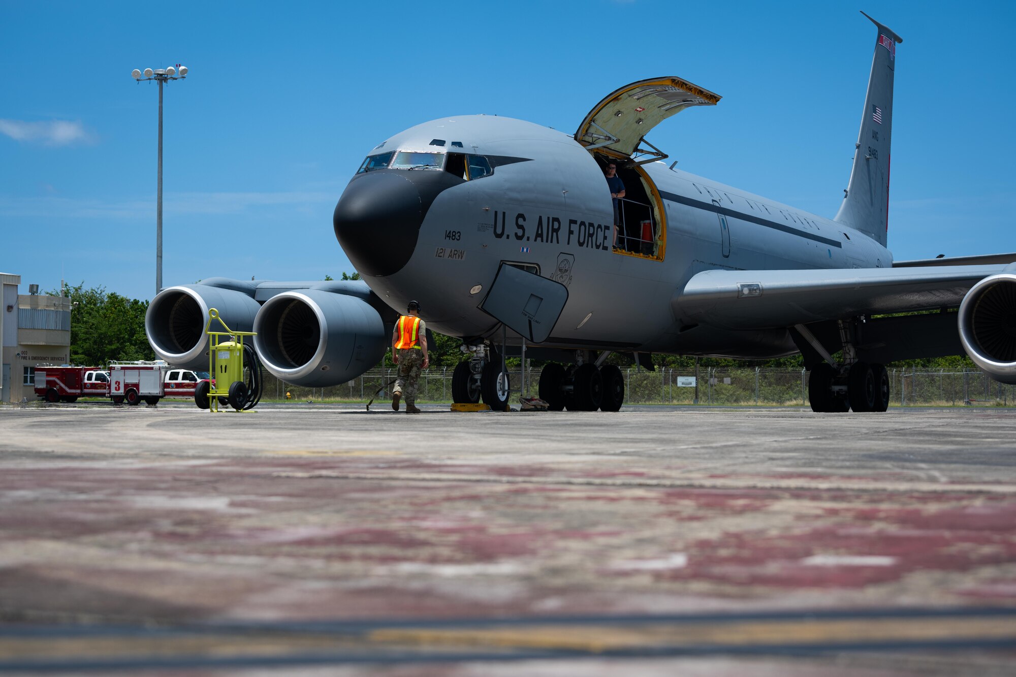 U.S. Air Force Master Sgt. Alexis Hernandez, an aerospace maintenance craftsman with the 156th Contingency Response Group, finishes marshaling a KC-135 Stratotanker, 121st Air Refueling Wing, Ohio Air National Guard, during Operation Hoodoo Sea exercise at Muñiz Air National Guard Base, Carolina, Puerto Rico, May 3, 2023. Operation Hoodoo Sea is a multi-unit training exercise where participant units conduct agile combat training in the coastal southeast of the U.S. to test agile communications innovations, portable aerospace ground equipment, aircraft concealment hangars and survival kits. (U.S. Air National Guard photo by 2nd Lt. Eliezer Soto)