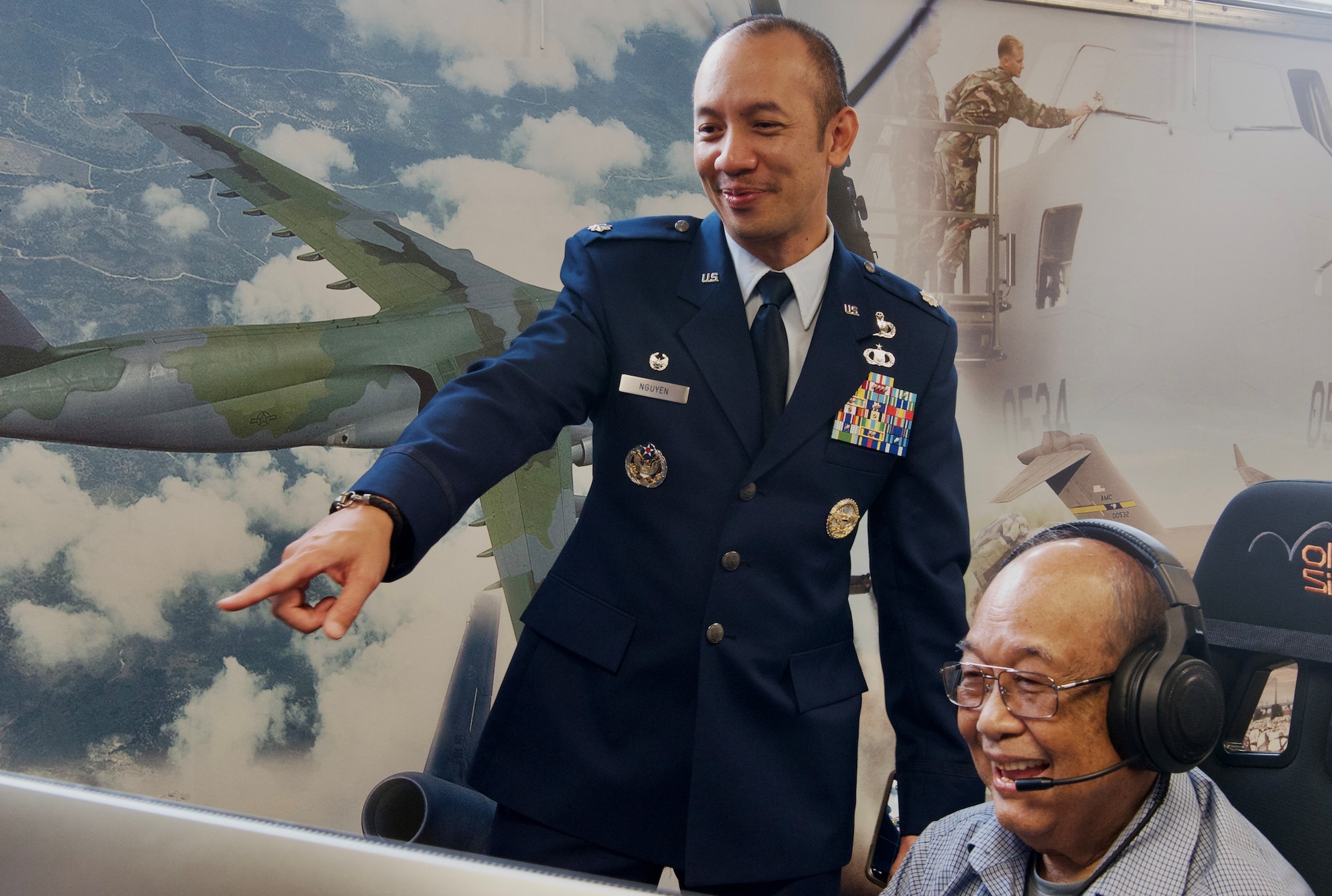 Thu Nguyen, DLIELC alumni, and his son Lt. Col. Quoc-nam Nguyen, test the Defense Language Institute Aviation Training Center aviation lab simulator.