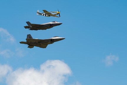 Aircraft fly in formation.