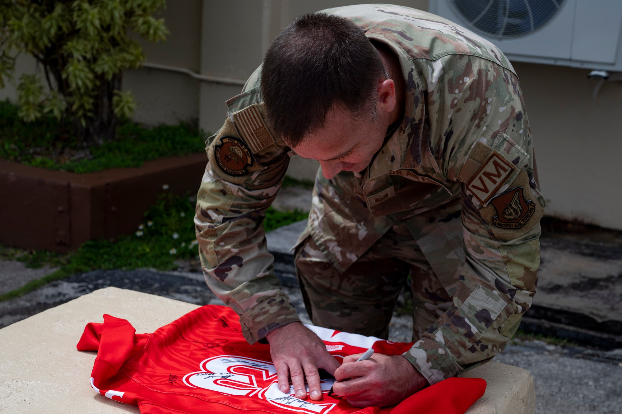 U.S. Air Force Tech. Sgt. Robert Pepper, the noncommissioned officer in charge of Silver Flag maintenance assigned to the 36th Logistics Readiness Squadron, signs the Linebacker of the Week jersey at Andersen Air Force Base, Guam, April 19, 2023. The Team Andersen Linebacker of the Week recognizes outstanding enlisted, officer, civilian and total force personnel who have had an impact on achieving Team Andersen’s mission, vision and priorities. (U.S. Air Force photo by Airman 1st Class Emily Saxton)