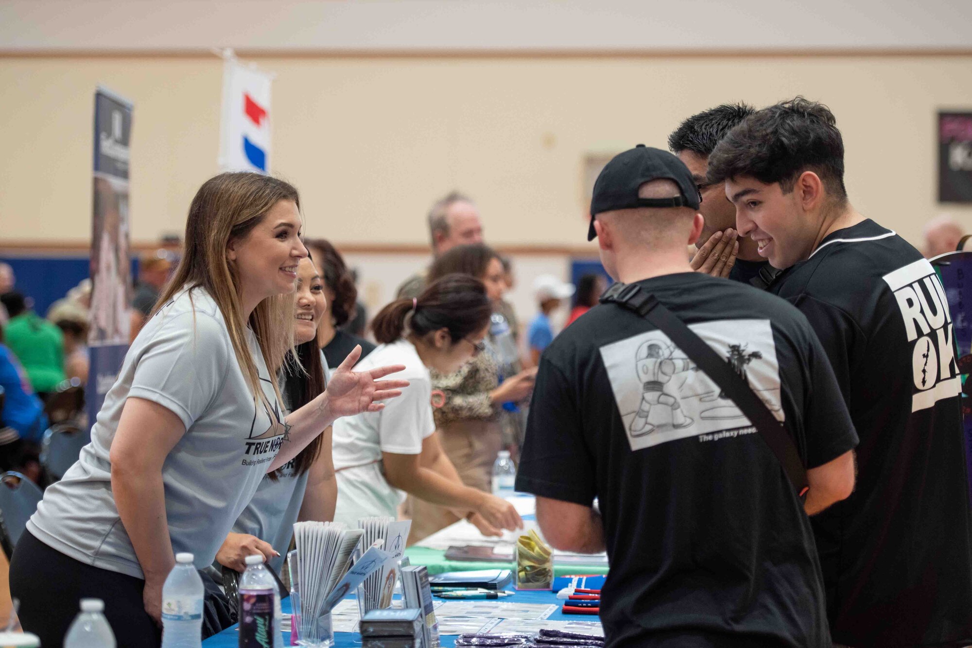 A helping agency representative speaks to event participants