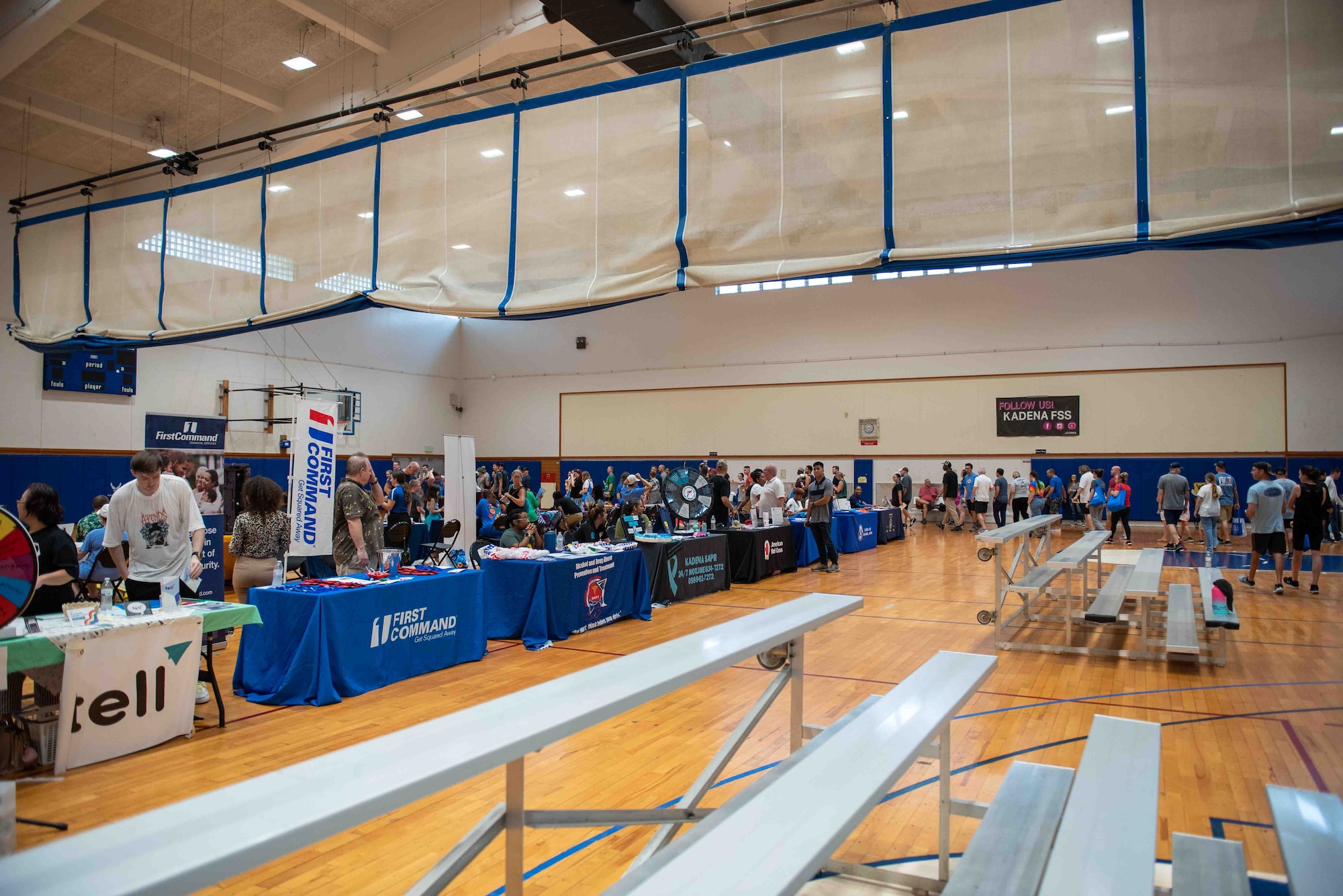 An event occurs inside of a gym with informational booths
