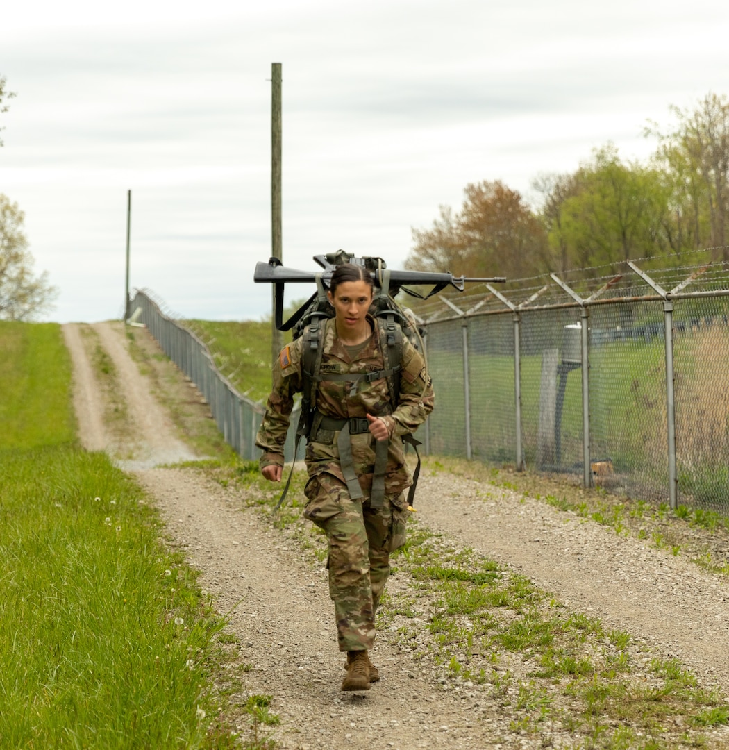 Sgt. Taylor Reichow, multiple launch rocket system crewmember, Battery B, 1st Battalion, 121st Field Artillery Regiment, 157th Maneuver Enhancement Brigade, Wisconsin Army National Guard, keeps pace during the 12-mile ruck march event at the 2023 Region IV Army National Guard Best Warrior Competition at Camp James A. Garfield Joint Military Training Center in Newton Falls, Ohio, May 7, 2023.