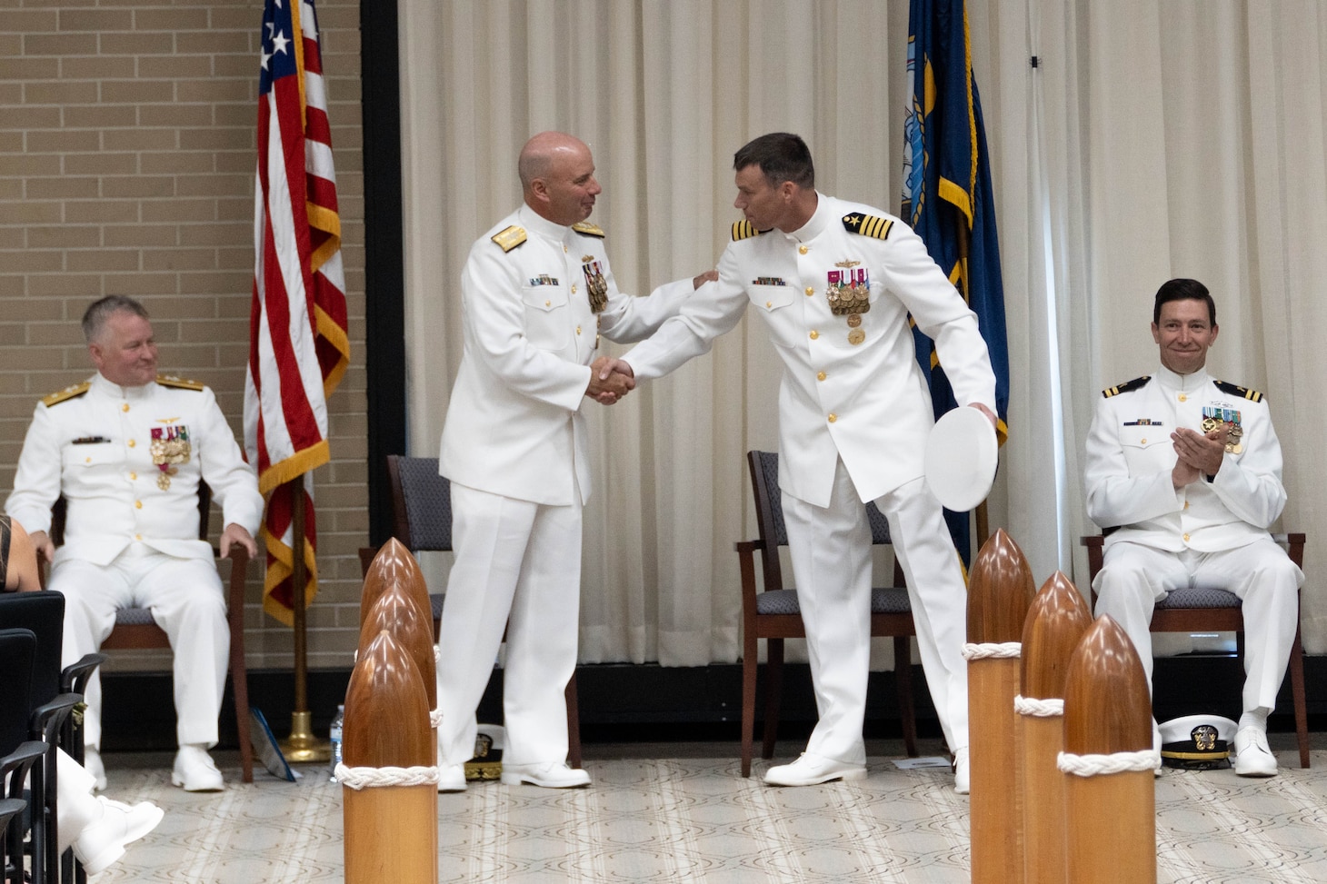 Vice Adm. James W. Kilby, deputy commander, United States Fleet Forces Command, left, congratulates Capt. Todd Whalen, oncoming president, Board of Inspection and Survey (INSURV), after reading his orders during the INSURV change of command ceremony. INSURV is responsible for inspecting the fleet’s in-service and new construction ships, determining their material readiness, and reporting this assessment to Congress, and Navy Leadership.