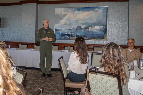 Rear Adm. John Meier speaks standing up in front of a crowd