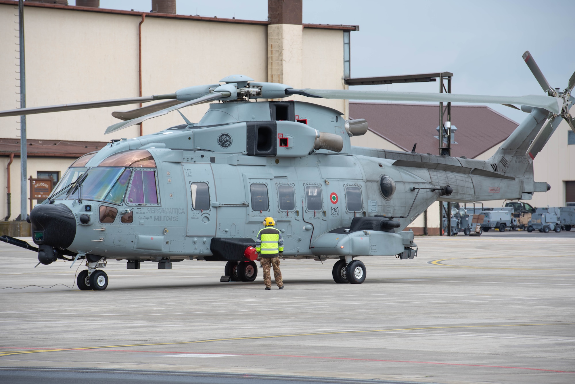 A man preps a helicopter before it departs.