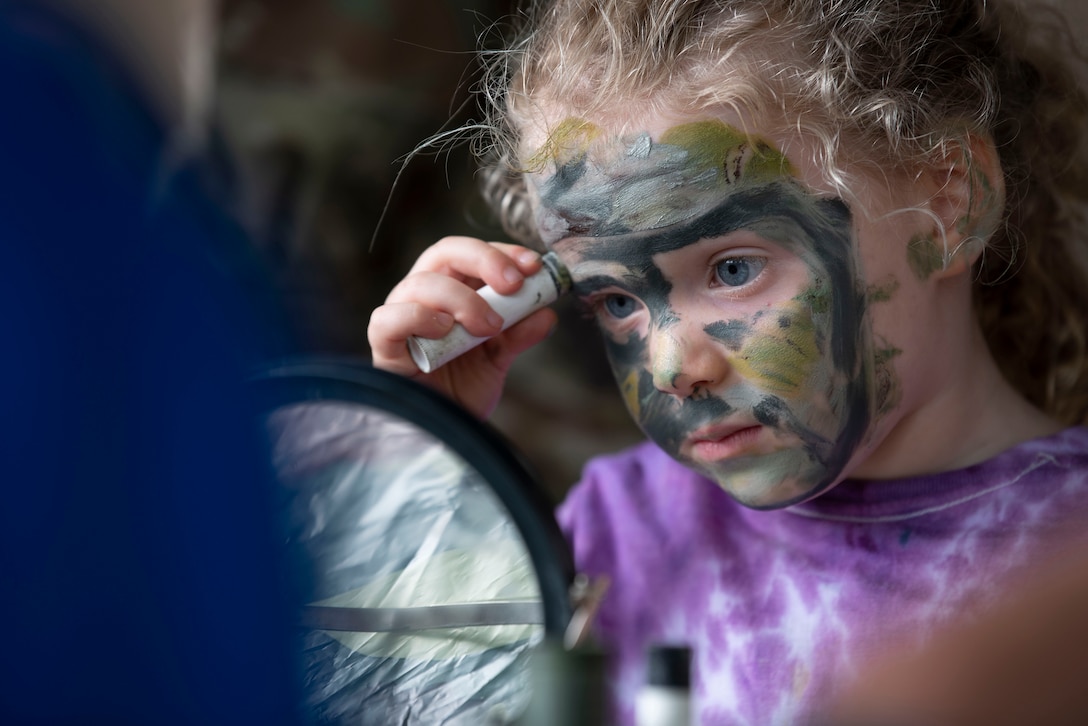 A child applies face paint.