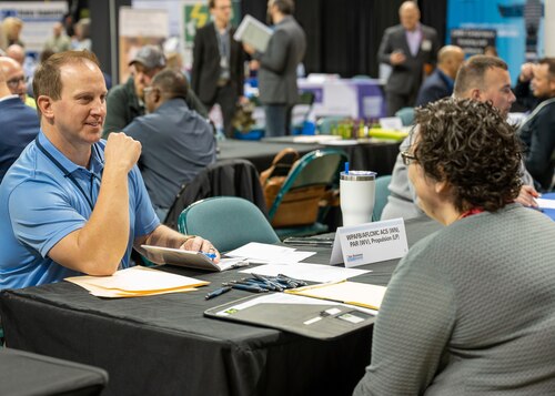 Individuals discuss AFLCMC business opportunities at Ohio Business Matchmaker event in Fairborn, Ohio on May 4, 2023 at the Nutter Center in Fairborn, Ohio. (U.S. Air Force photo by Staff Sgt. Mikaley Kline).
