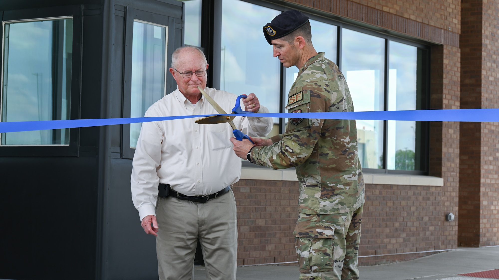 Mike Pence, co-president of Howard W. Pence, Inc. and U.S. Air Force Lt. Col. Stephen Addington, 509th Security Forces Squadron, commander cut the ribbon for LeMay Gate’s reopening at Whiteman AFB, Mo., April 5, 2023. Howard W. Pence, Inc. contributed to the work improving LeMay Gate’s infrastructure. (U.S. Air Force Airman 1st Class Hailey Farrell)