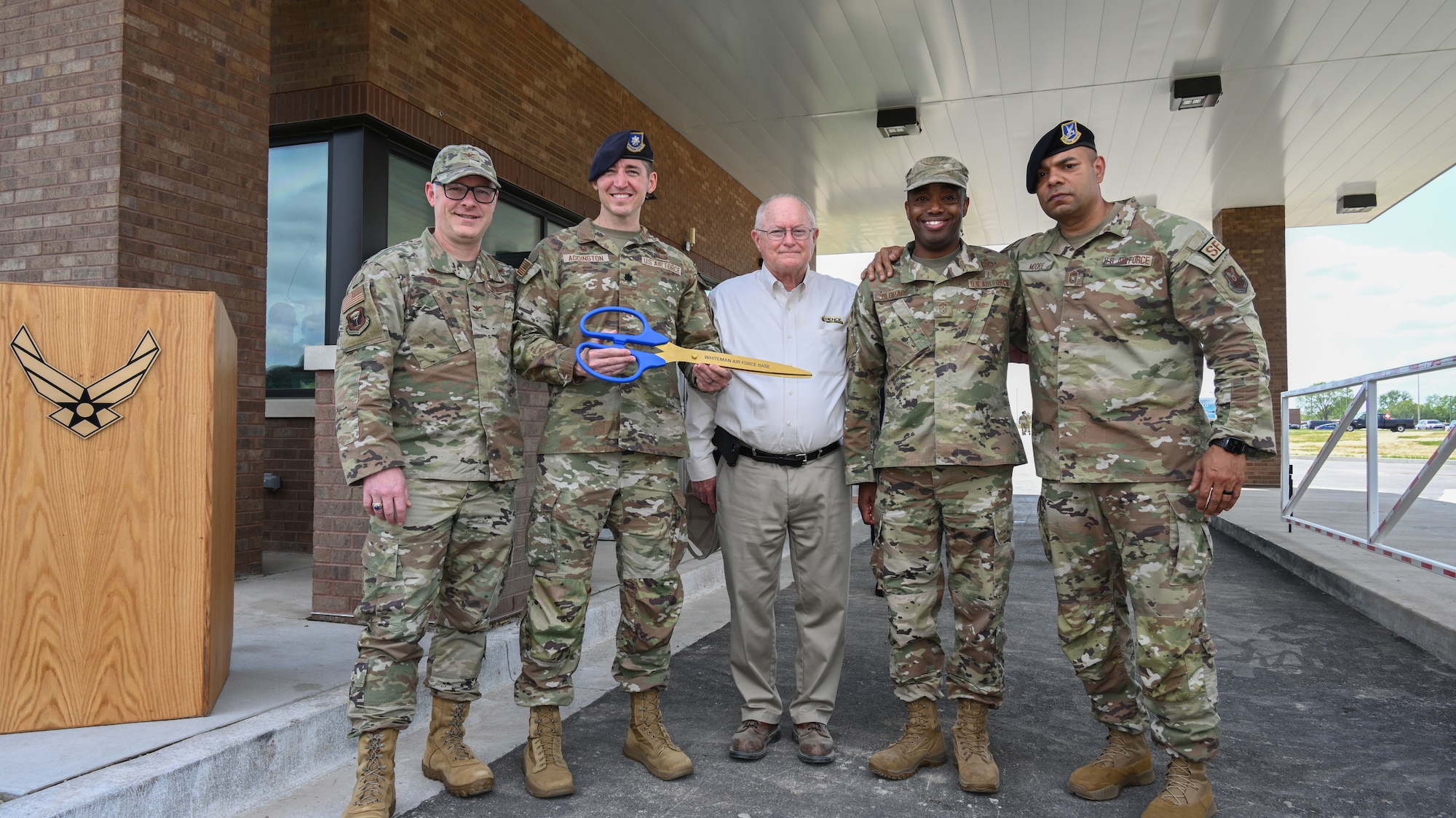 U.S. Air Force Airmen and community leaders pose for a photo during the ribbon cutting ceremony for LeMay Gate at Whiteman Air Force Base, Mo., April 5, 2023. LeMay Gate officially reopened after construction to improve the gate’s infrastructure concluded. (U.S. Air Force photo by Airman 1st Class Hailey Farrell)