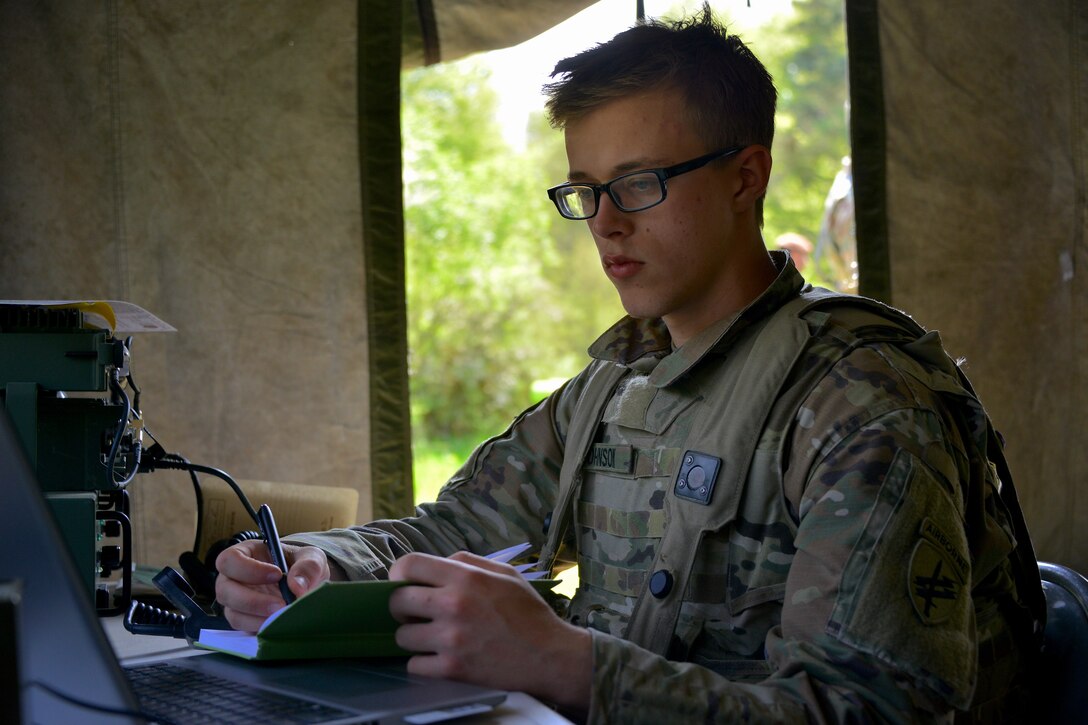 Spc. Justin Johnson, a civil affairs specialist with C Co/418th Civil Affairs Battalion, monitors SINCGAR RT-1523 VHF Radio channels and information within a civil-military operations center (CMOC) during Exercise Combined Resolve 18 here on May 5, 2023. Combined Resolve 18 includes NATO countries and partner nations and strengthens interoperability between NATO allies and partner nations.