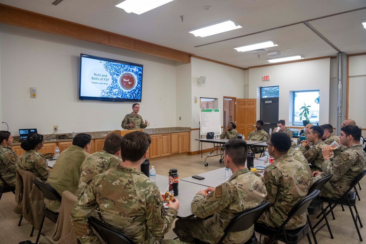Chaplain (Capt.) Jacob Wilde, 22nd Air Refueling Wing Chaplain, briefs the first class of Airman participating in the Peer-to-Peer initiative at McConnell Air Force Base, Kansas, May 1, 2023. The Peer-to-Peer initiative aims to establish close-knit bonds among a small group of Airman facilitating genuine conversations and exploring the full range of resources that the installation agencies have to offer. (U.S. Air Force photo by Airman Gavin Hameed)