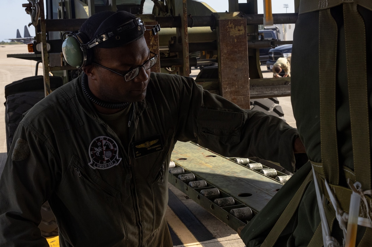 A Marine loads cargo.