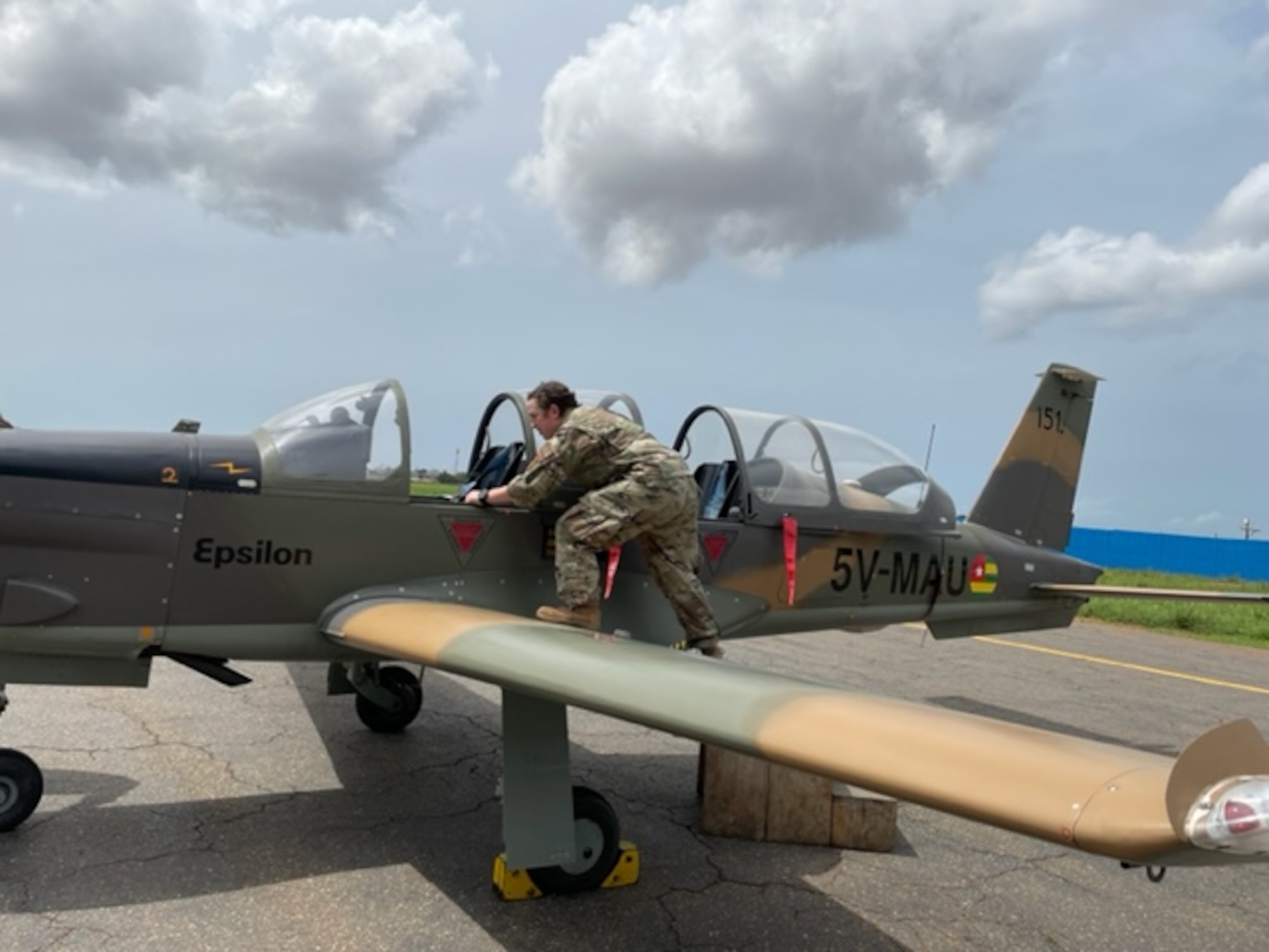 U.S. Air Force Tech. Sgt. Clarissa Grizzle, 818th Mobility Support Advisory Squadron transmission systems technician, inspects local communications equipment and capabilities of Togolese aircraft.
