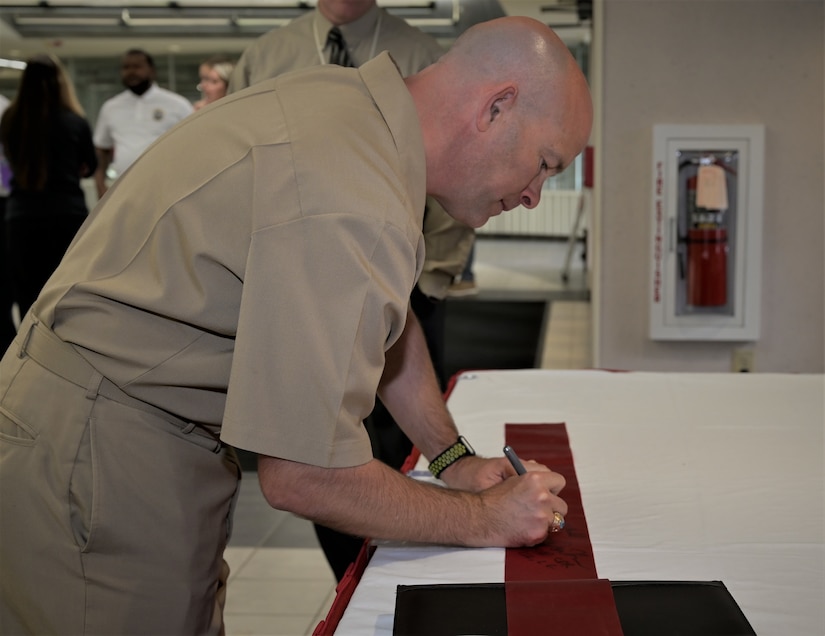 Photo of ribbon signing