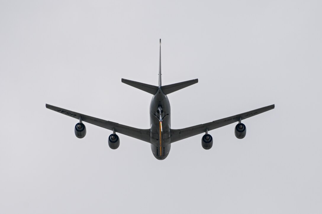 A KC-135 Stratotanker completes a flyover during the Shell 77 memorial at Altus Air Force Base, Oklahoma, May 3, 2023. The KC-135 held an aerial refueling position with the boom down during the flyover. (U.S. Air Force photo by Senior Airman Kayla Christenson)