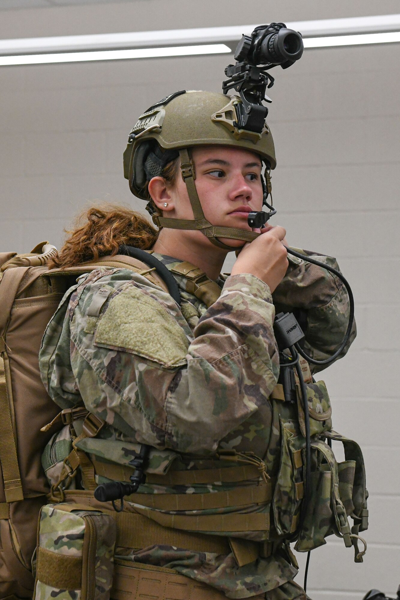 woman in uniform prepares her equipment