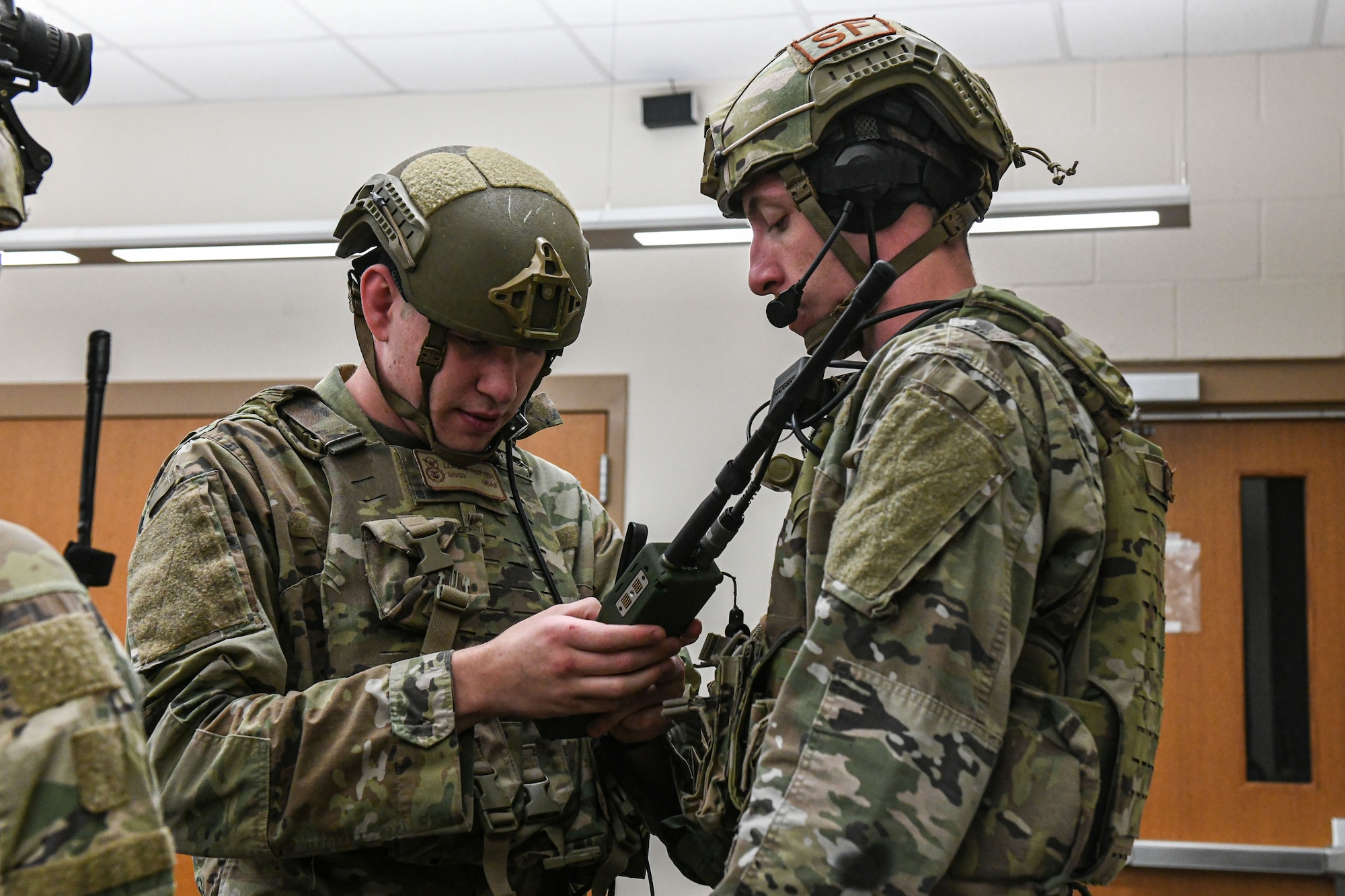 men in uniform prepare their equipment