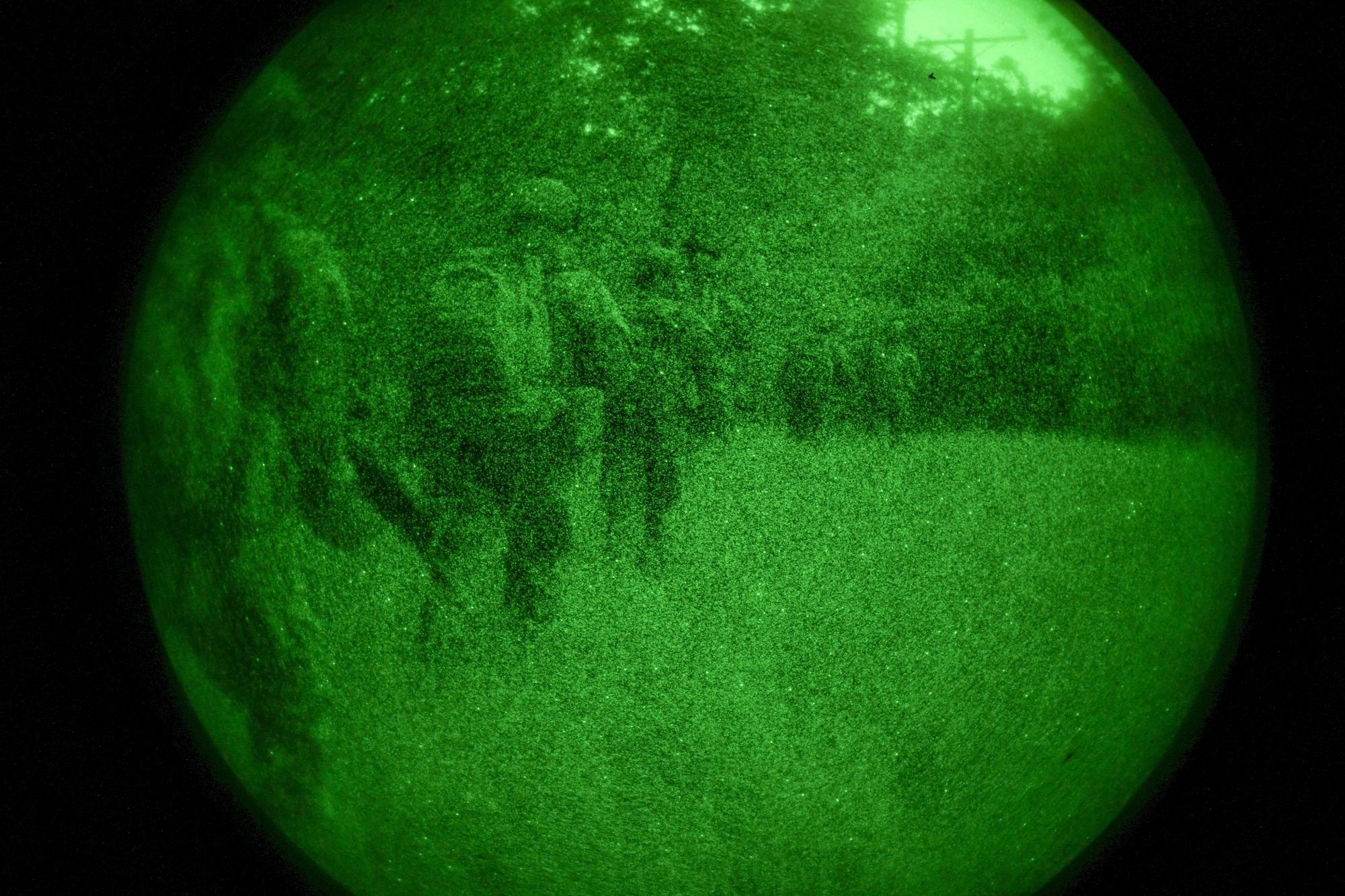 men and women in uniform patrol through the woods