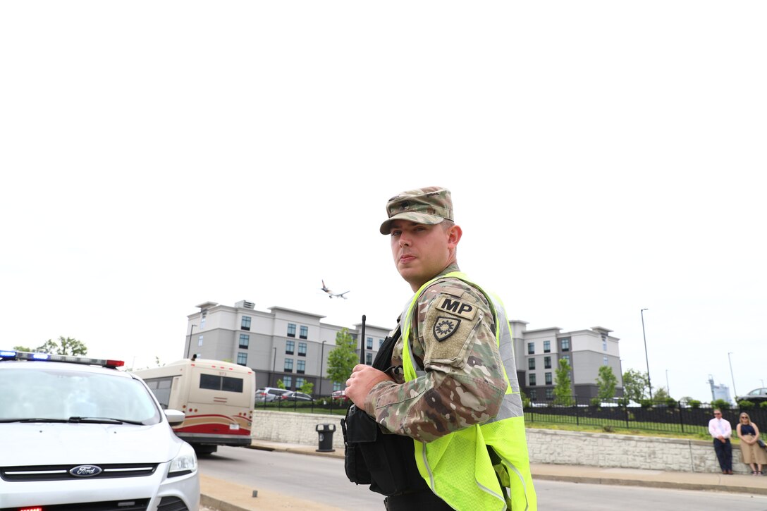 Spc. Derrick Gray from the 617th Military Police Company provides traffic security outside Churchill Downs in Louisville, Ky., May 6, 2023