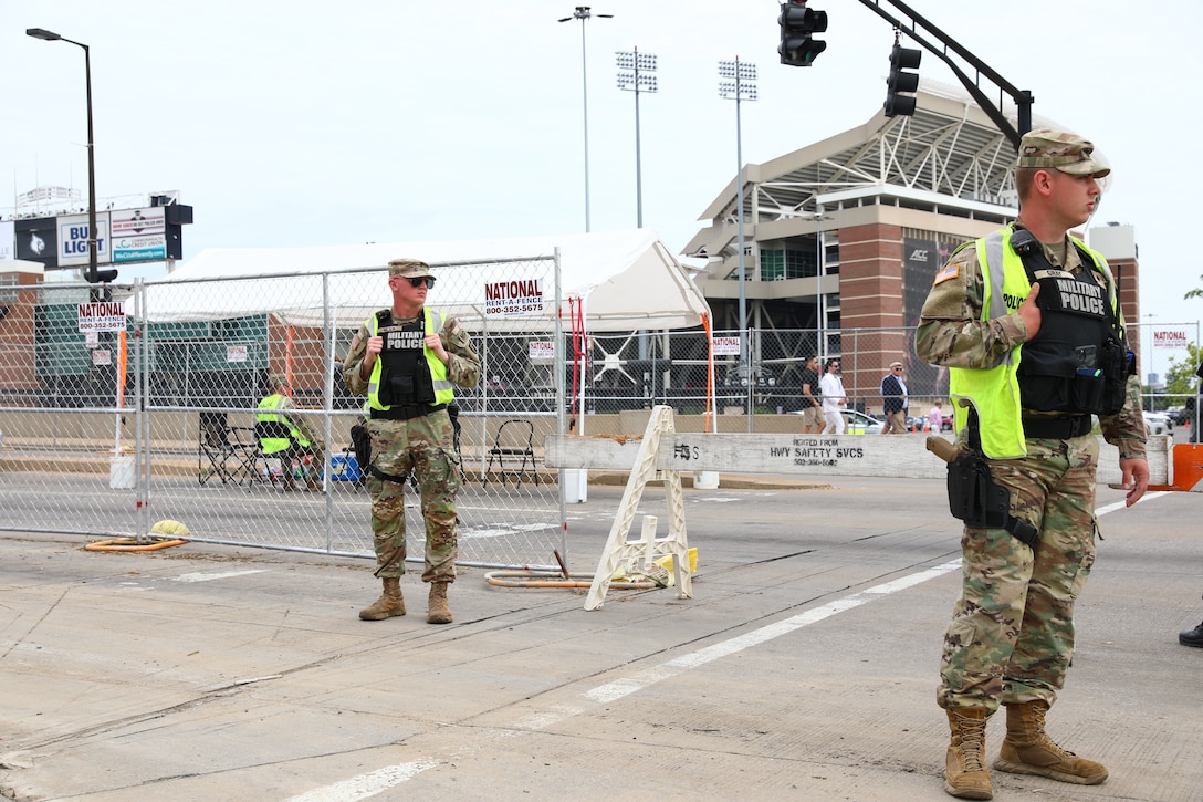From left, Specialists. Tyler Wilson and Derrick Gray, both from 617th Military Police Company provide traffic security outside Churchill Downs in Louisville, Ky., May 6, 2023