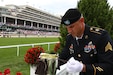 Sgt. Matt Broce, with the 617th Military Police Company, puts the Kentucky Derby Trophy back in the box after showing it in the winner’s circle prior to the Kentucky Derby in Louisville, Ky., May 6, 2023. The trophy is six pounds of solid gold and is awarded to the first-place winner of the Derby.