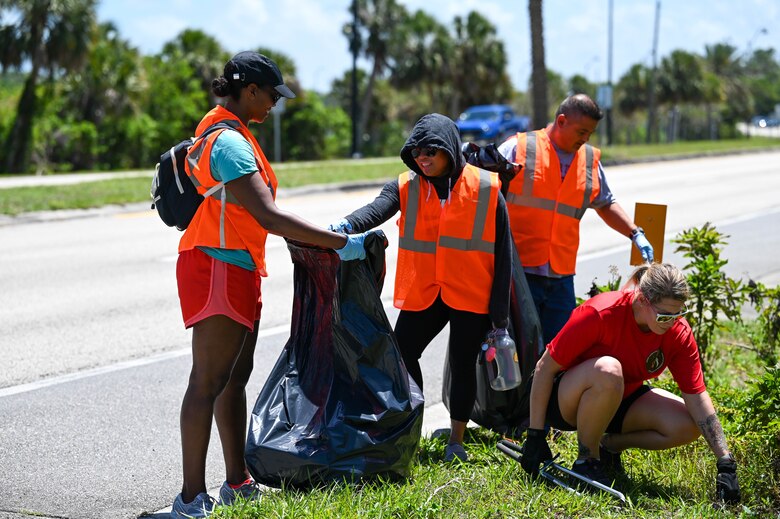 Members from 45th LRS clean a section of highway adopted in honor of Staff Sgt. Andrew Holman, 45th LRS air traffic controller on April 21, 2023 in Melbourne, Fla., Memorial Markers are signs posted at sites of incidents to remind others to drive safely. (U.S. Space Force photo by Senior Airman Samuel Becker)
