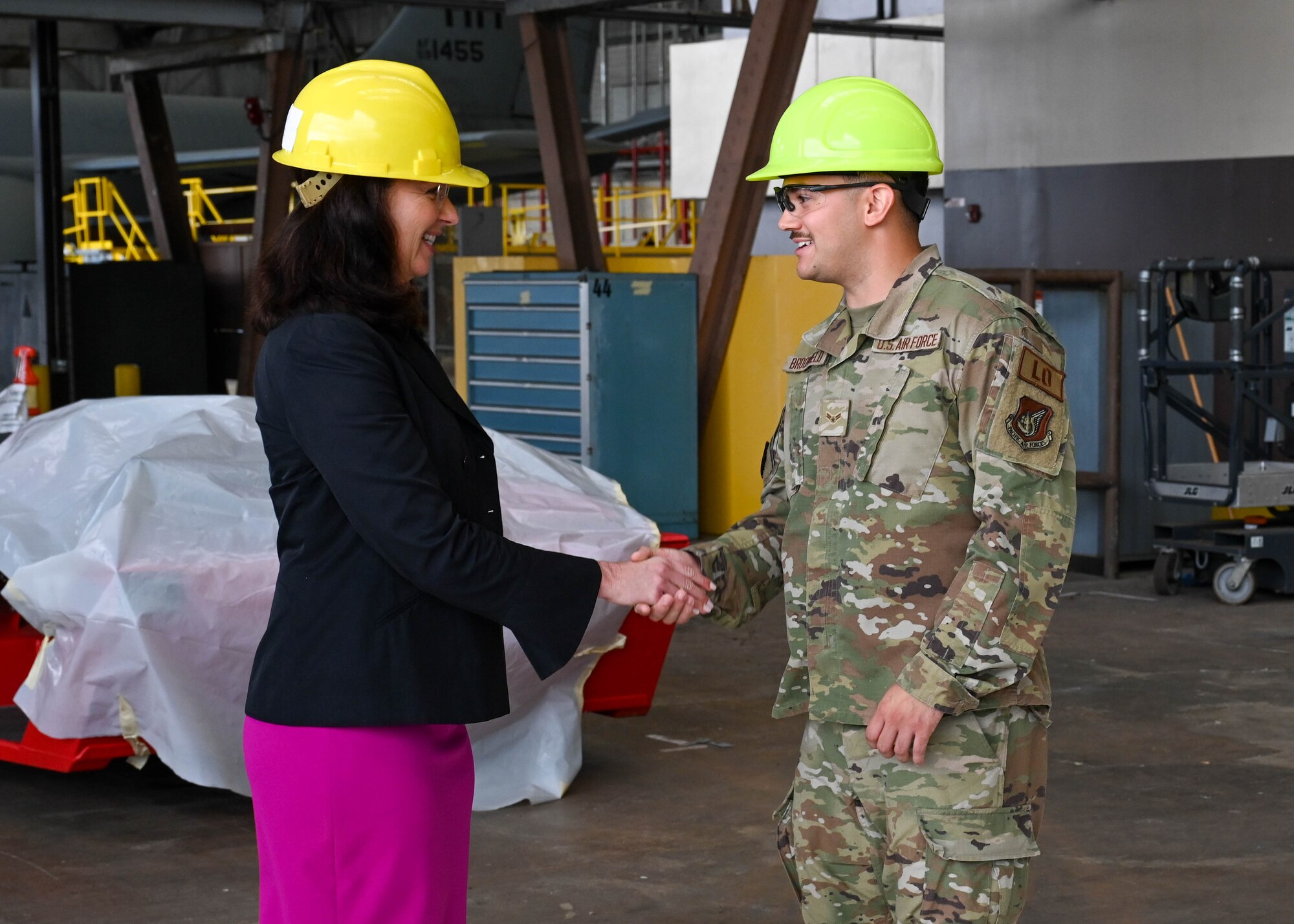 Kristyn Jones, assistant secretary of the Air Force for Financial Management and Comptroller, performing the duties of under secretary of the Air Force coins Airman 1st Class Logan Broomfield, 15th Maintenance Squadron low observable aircraft structures technician, during her visit to Joint Base Pearl Harbor-Hickam, Hawaii, May 2, 2023. Broomfield was lauded for exemplary work in his career field and his dedication to the Air Force core values. (U.S. Air Force photo by Senior Airman Zoie Cox)