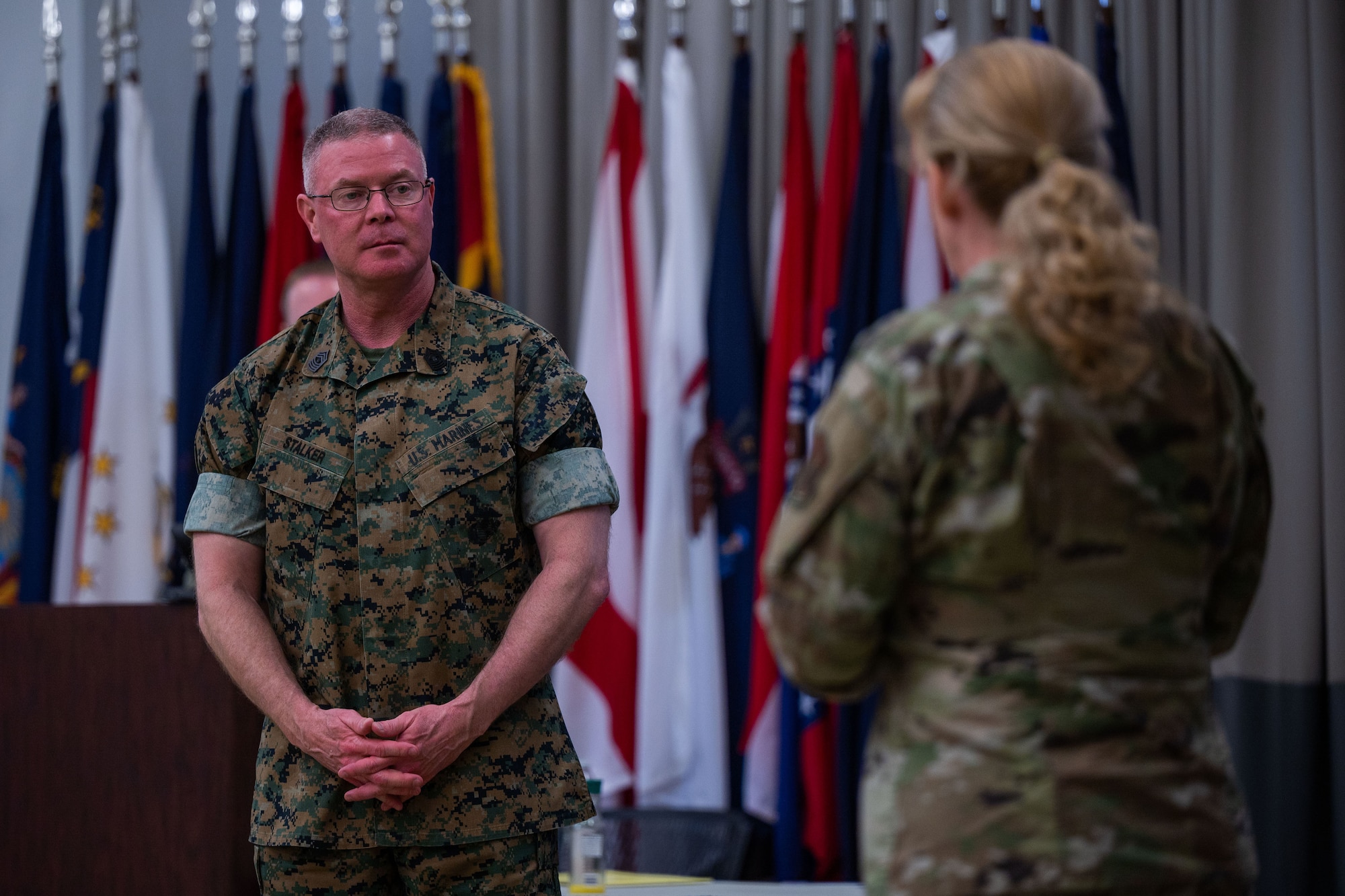 U.S. Marine Corps Master Gunnery Sgt. Scott H. Stalker, U.S. Space Command (USPACECOM) command senior enlisted leader, left, listens to U.S. Air Force Col. Karen Slocum, 9th Combat Operations Squadron (9 COS) commander, at Space Delta 1’s auditorium on Vandenberg Space Force Base, Calif., May 6, 2023. Stalker gave a mission brief of USSPACECOM and how the 9 COS plays a vital role in space operations. The 9 COS is an Air Force Reserve Command space operations unit and is the Reserve Associate unit to Space Delta 5, which augments intelligence, planning and operations at the Combined Space Operations Center. (U.S. Space Force photo by Tech. Sgt. Luke Kitterman)